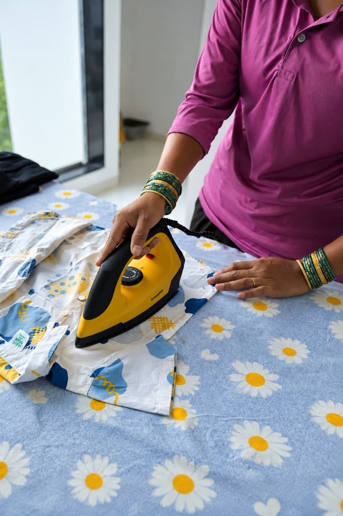 maidigo professional ironing clothes on ironing board